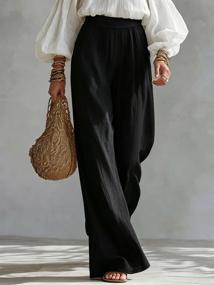 Andrea | Conjunto con top blanco de hombros descubiertos y pantalones negros palazzo